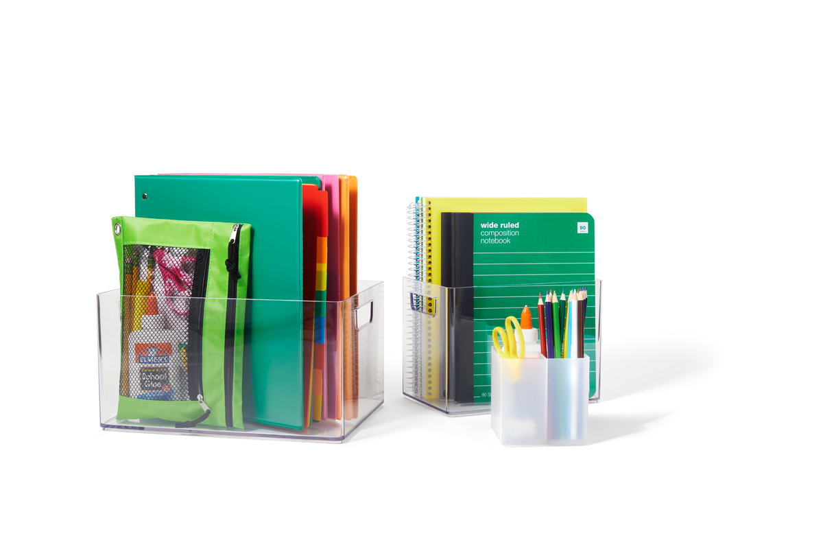 Two sets of schoolbooks and notebooks in clear holders with a pencil cup in front
