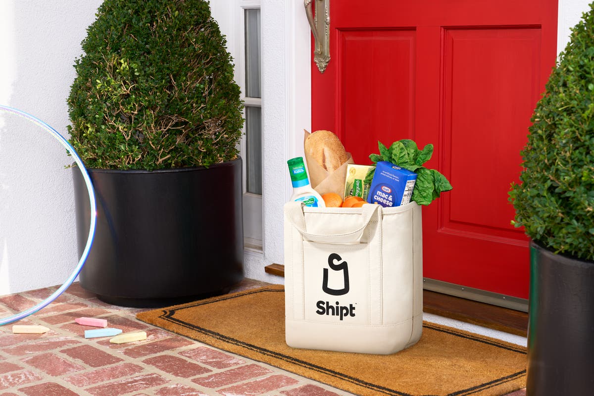 Full bag of groceries being delivered to front door