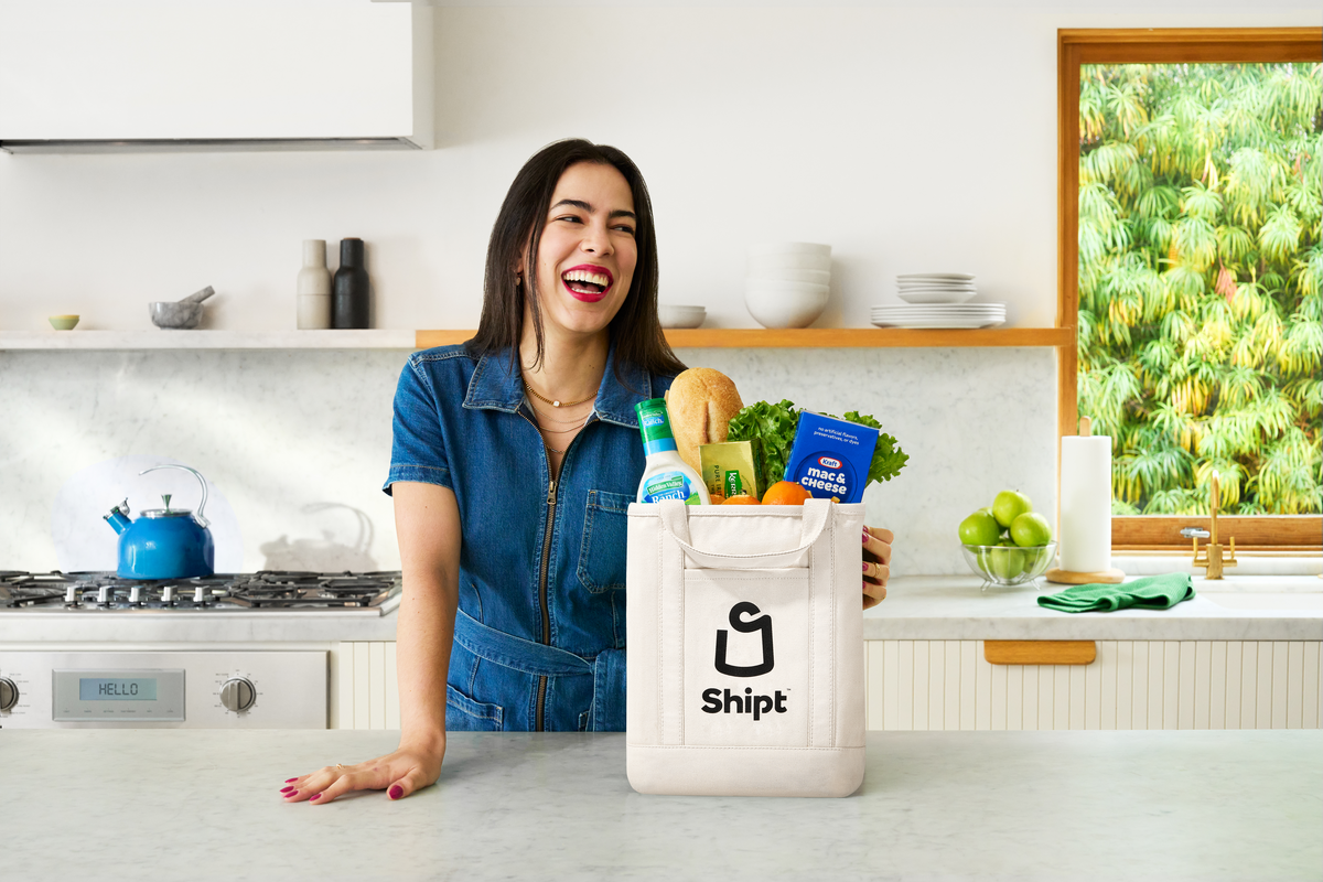 Woman smiling and looking at phone screen