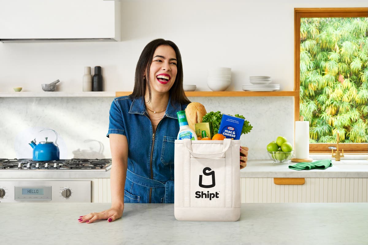 Woman smiling and looking at phone screen