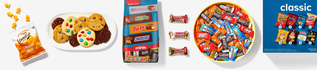 small bag of goldfish, small platter of cookies, multi bag of candy, bowl of miniature candy, box of multi pack chips 