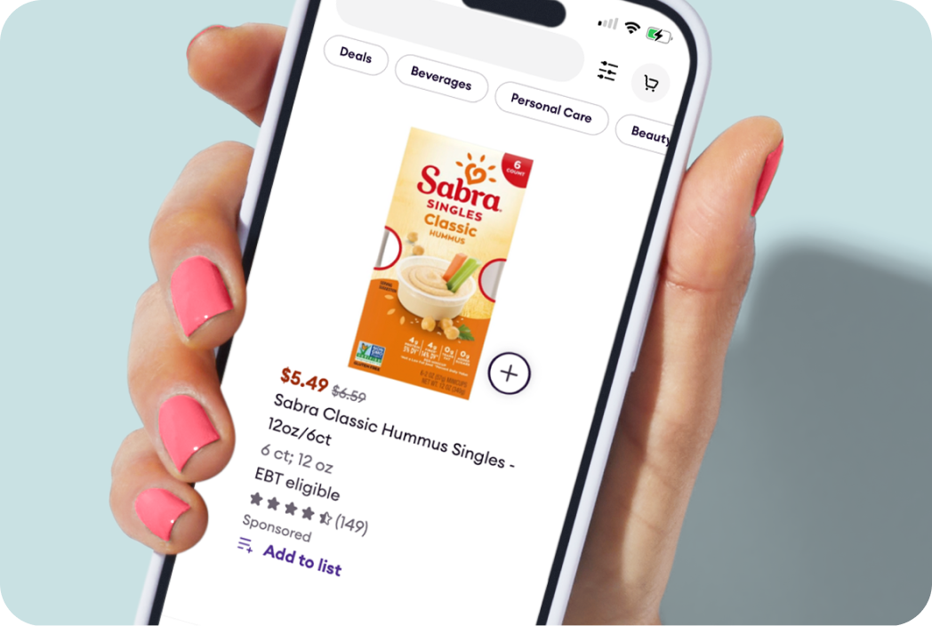 Hand holding a phone showing Sabra Hummus product.