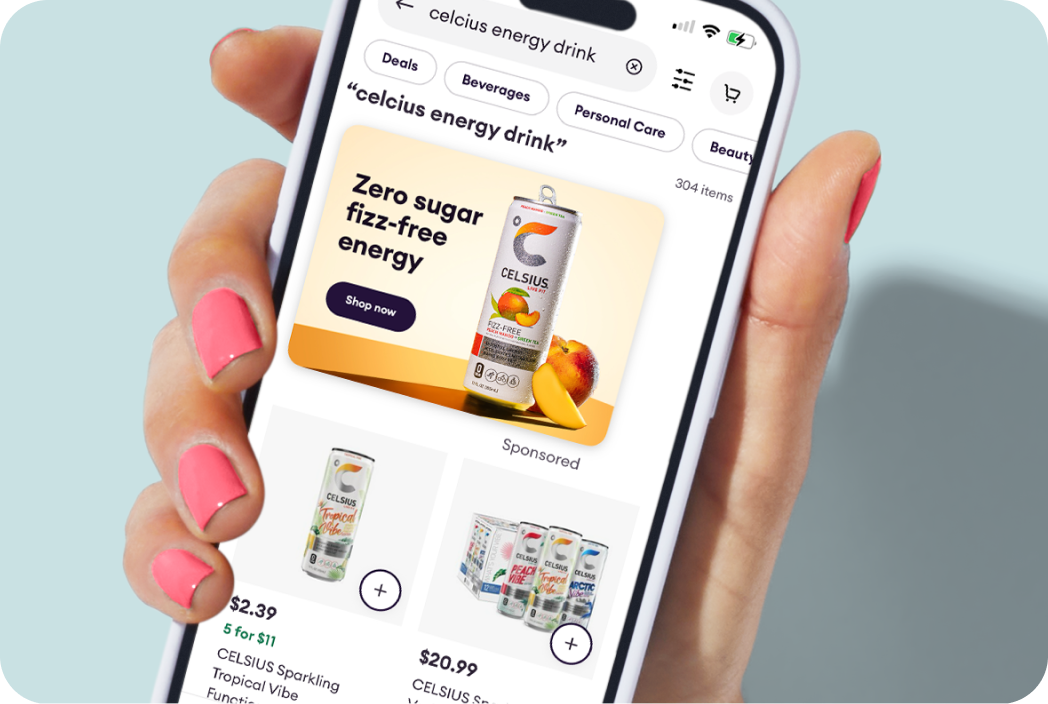 Hand holding a phone showing an ad type in the Shipt app. 