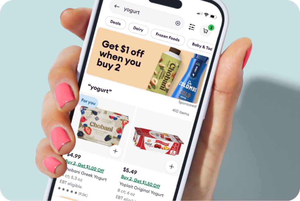 Hand holding a phone showing a banner ad  type in the Shipt app. 