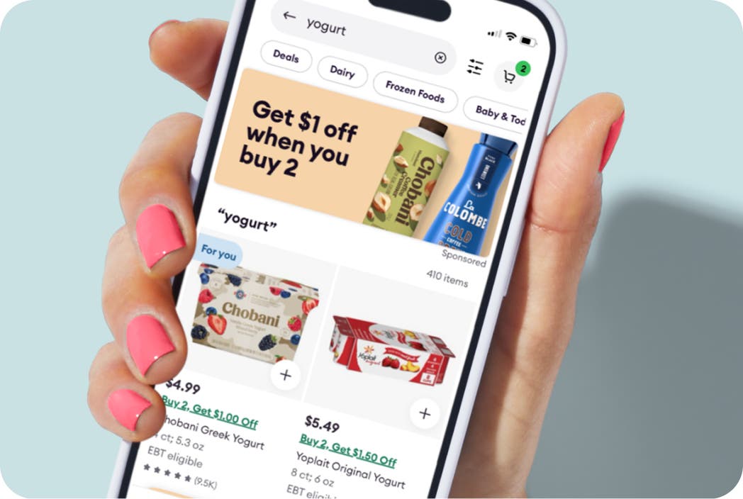 Hand holding a phone showing a banner ad type in the Shipt app.