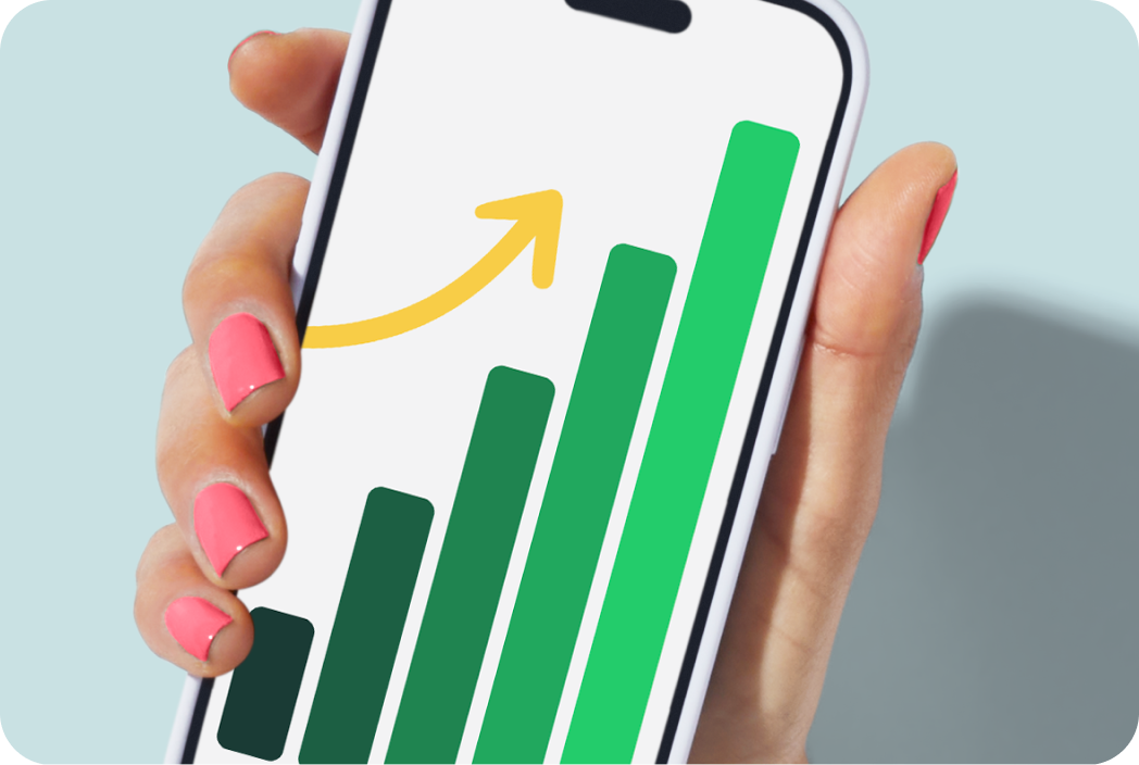 Hand holding a phone showing a bar chart. 