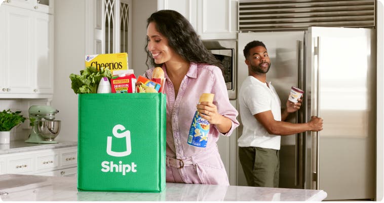 A customer unpacking their bag of Shipt groceries