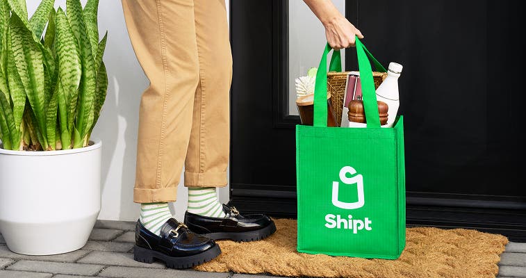 Full bag of groceries being delivered to front door