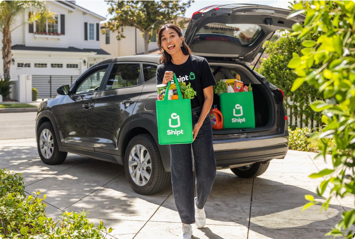 Shopper unloading Shipt delivery from car