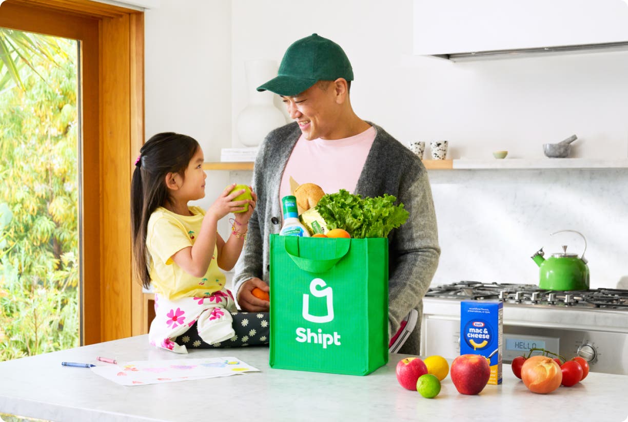 A father and daughter unpack their same-day grocery delivery