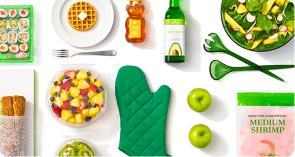 A selection of groceries and kitchen accessories against a white background