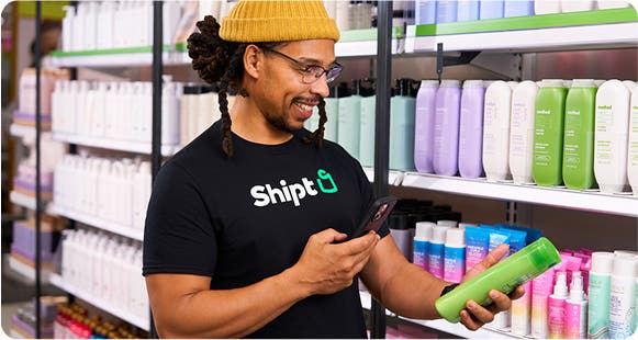 A shopper with Shipt selecting and scanning items for delivery