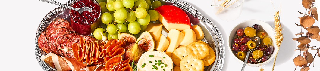 Silver tray of charcuterie small  bowl of olives 