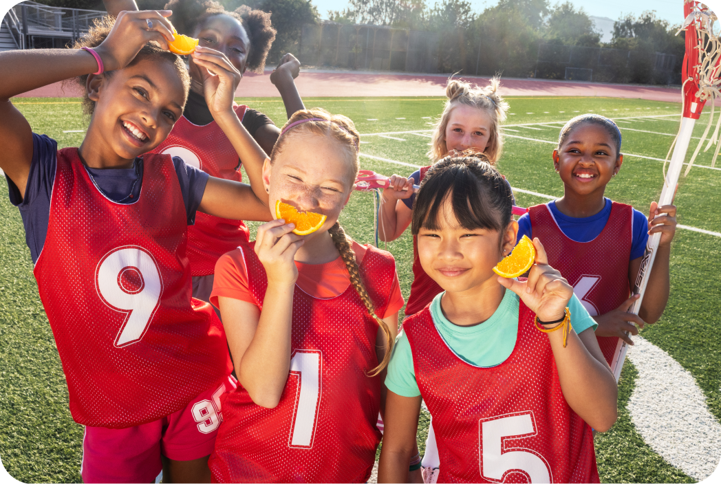 Lacrosse sports team eating oranges
