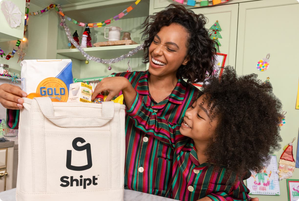 Family taking Christmas cooking essentials out of a Shipt bag