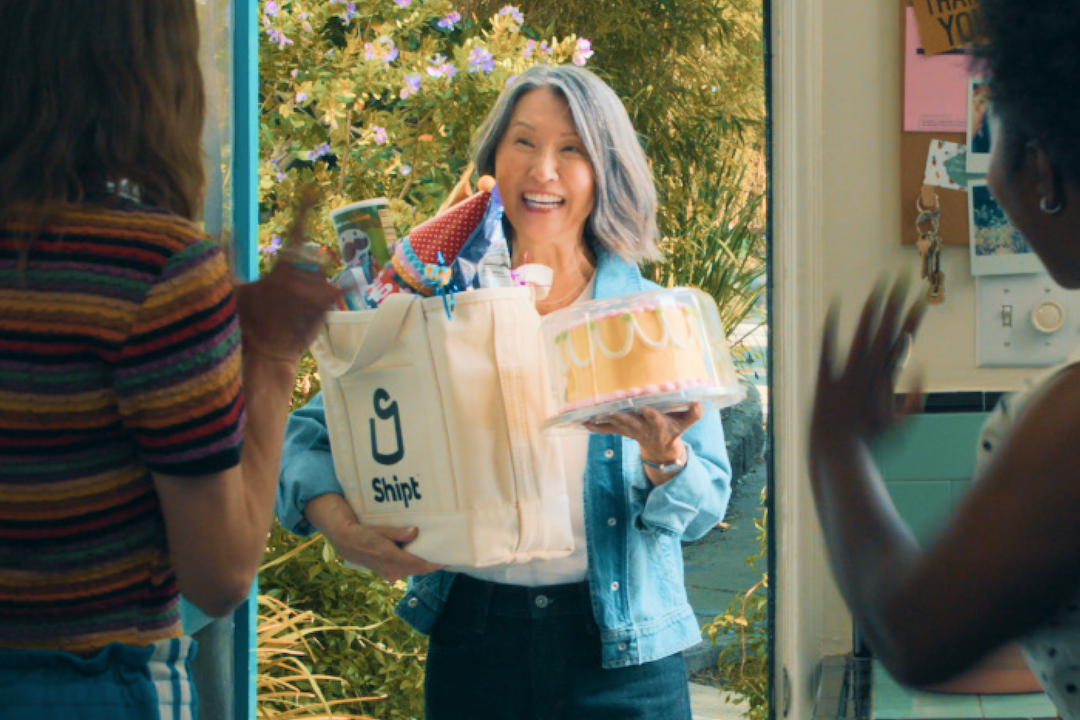 Image of shopper delivering cake and party supplies.
