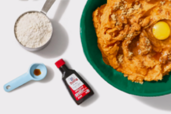 measuring cup of flour, bottle of vanilla flavoring, mixing bow of pie filling