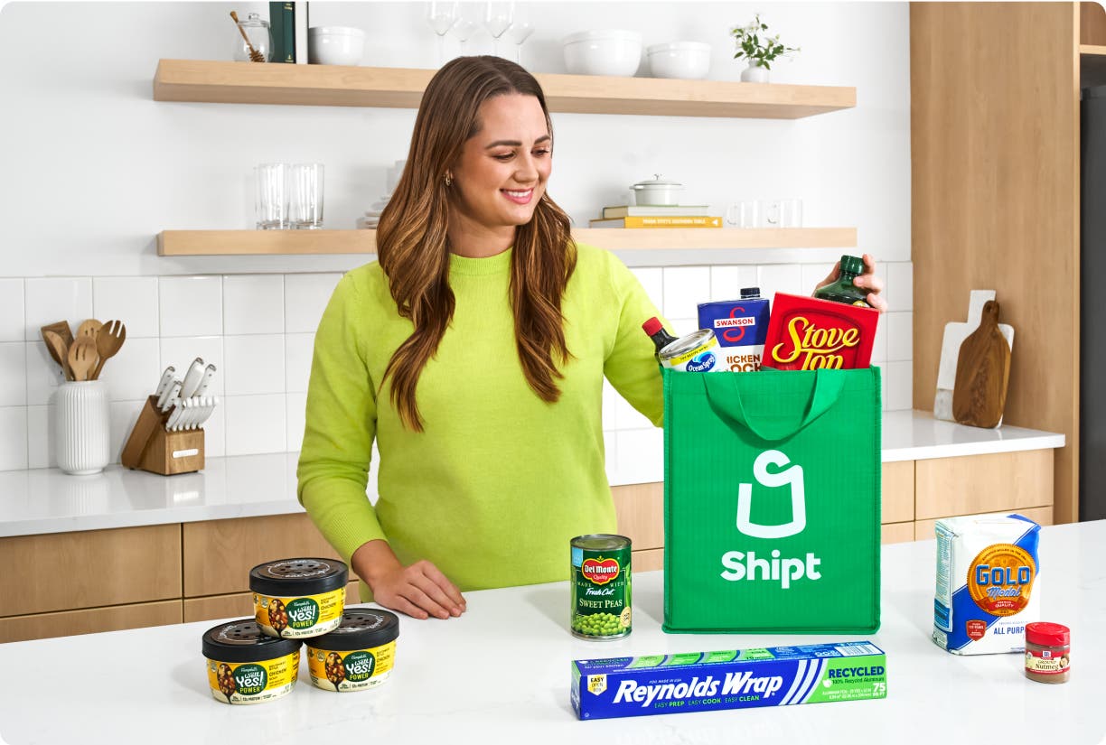 Person at kitchen counter unpacking a Shipt delivery