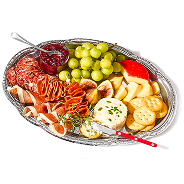 charcuterie plate of salami, cheese, grapes, jelly