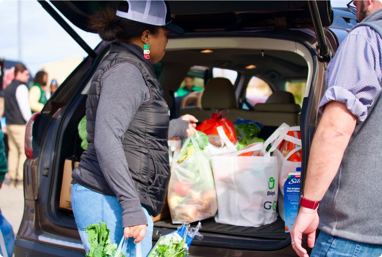 woman loading groceries into car