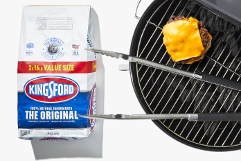 Grill with burger and grilling supplies