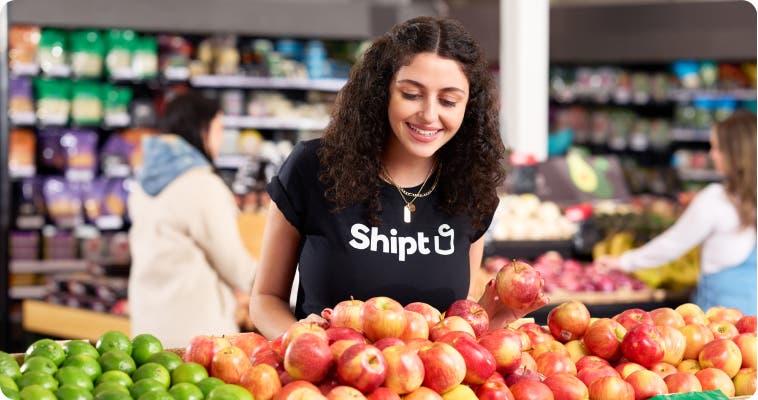 A shopper handpicking the best produce