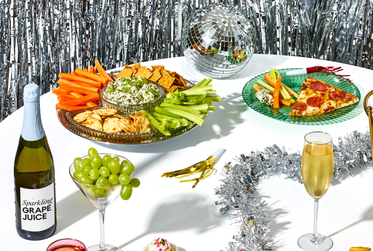 New Year's table set with appetizers, drinks, and decor