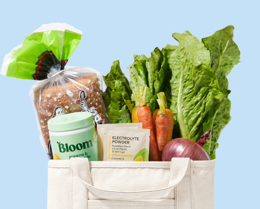 Shipt bag with healthy New Year's Day fruits, bread, and vegetables
