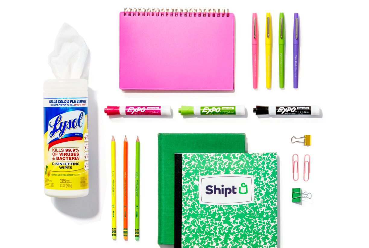Colorful selection of notebooks, dry erase markers, pencils, and pens on a white background