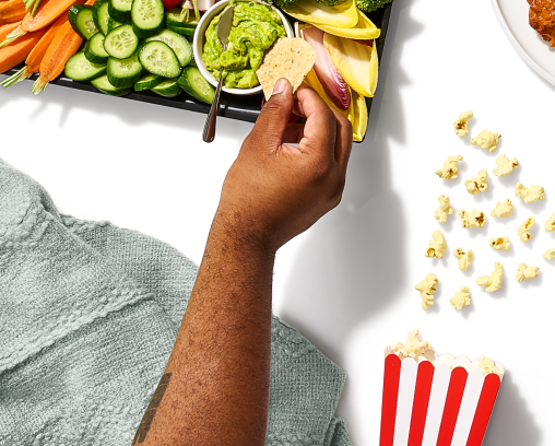 Close-up of person enjoying party food tray