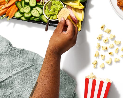 Close-up of person enjoying party food tray
