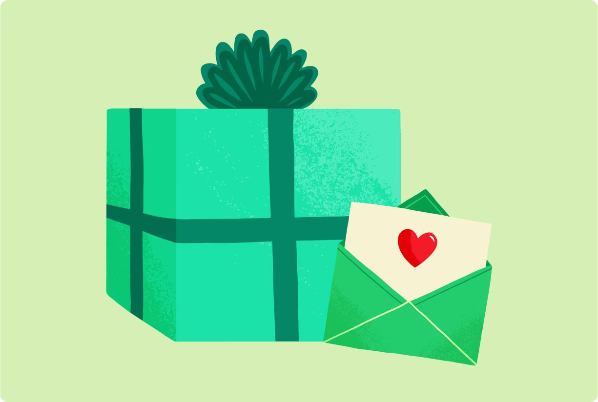 A green gift box with a card