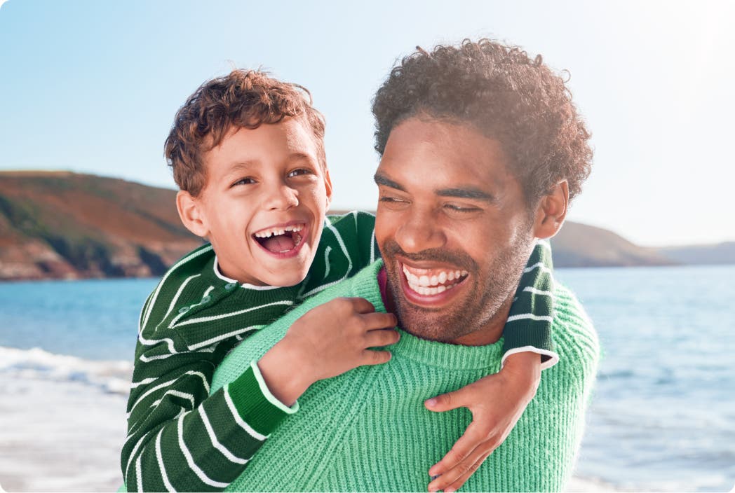 dad with son on beach