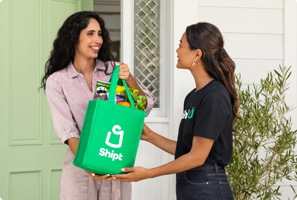 Shopper handing off groceries to customer