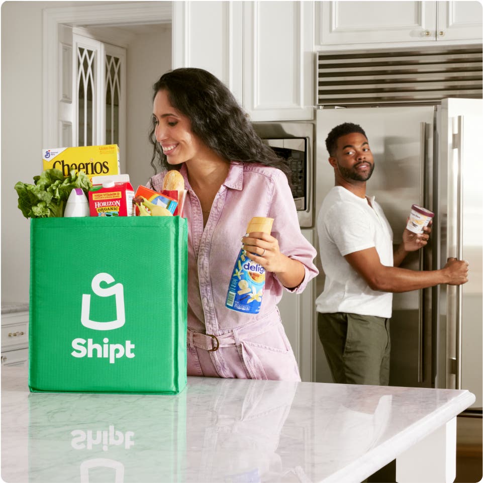 Woman unpacks bag of Shipt groceries