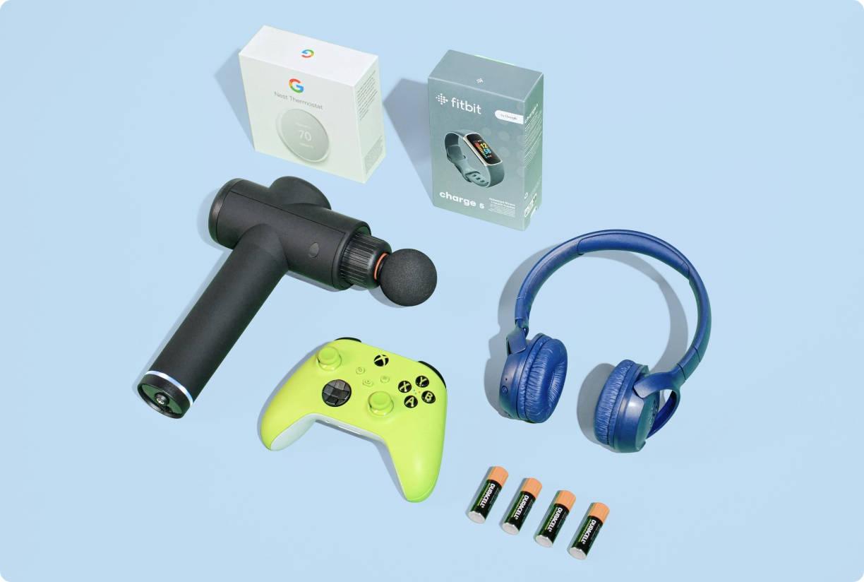 Electronic devices (Xbox controlled, TheraGun, headphones, batteries, FitBit, and a Nest Thermostat) on a green background