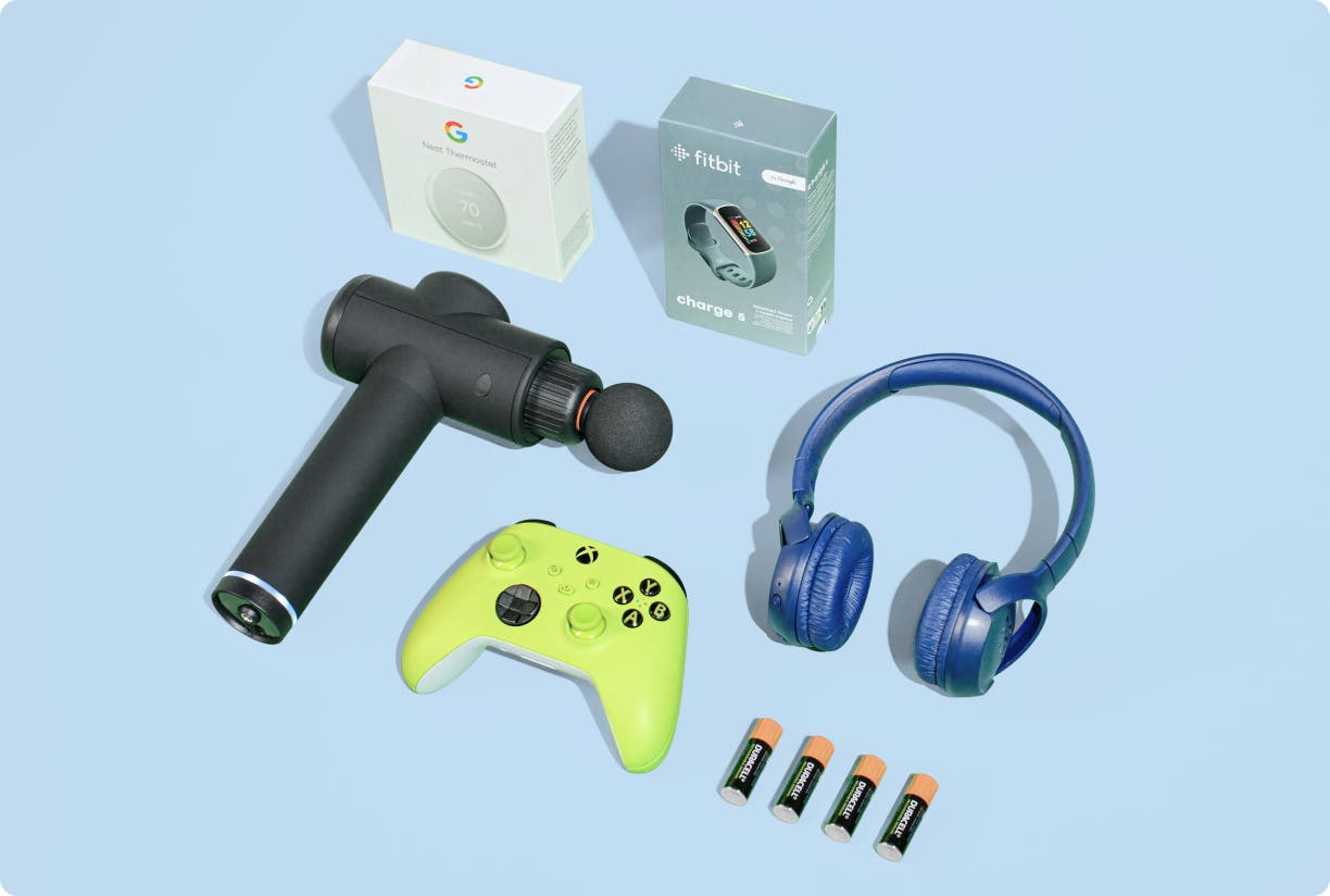 Electronic devices (Xbox controlled, TheraGun, headphones, batteries, FitBit, and a Nest Thermostat) on a green background