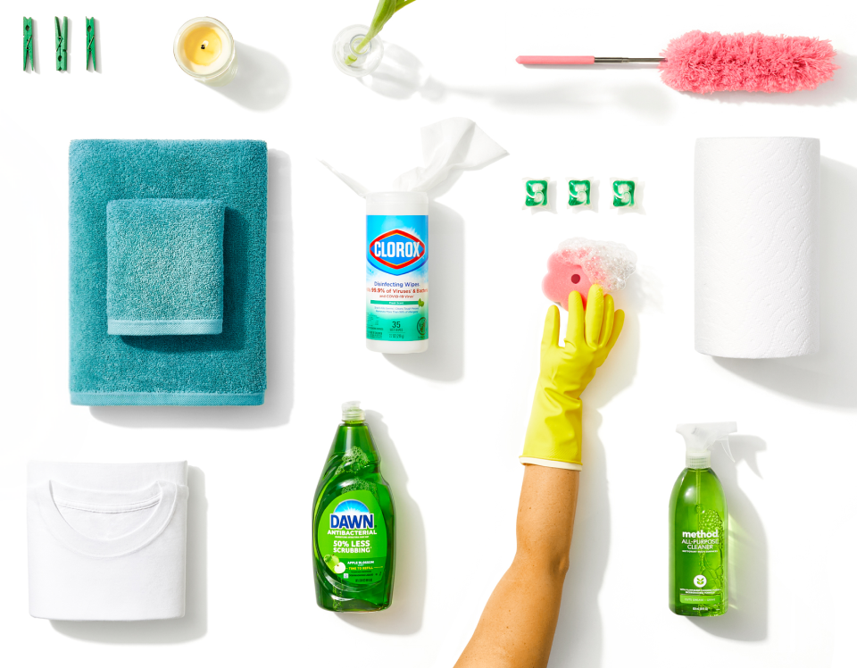 Various green-colored household supplies, like Dawn, Clorox wipes, and Method cleaner, on a white background