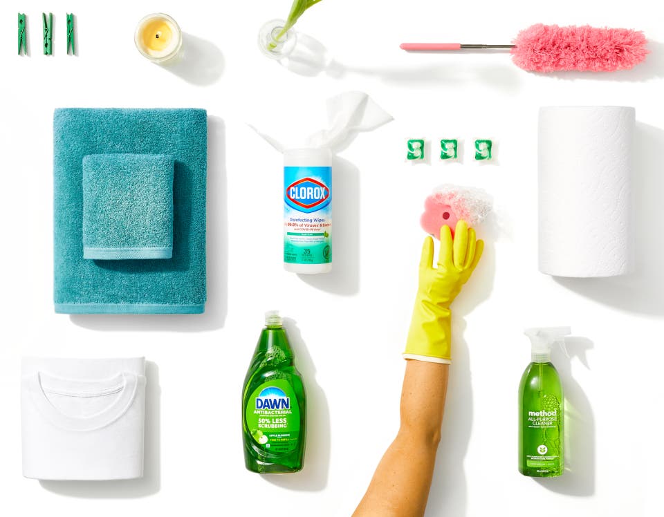 Various green-colored household supplies, like Dawn, Clorox wipes, and Method cleaner, on a white background