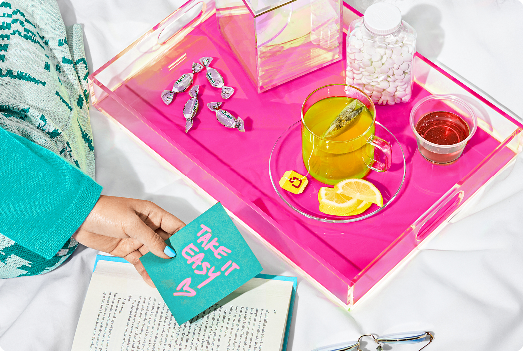 tray of tea, tissues and cough drops with a note saying "take it easy"