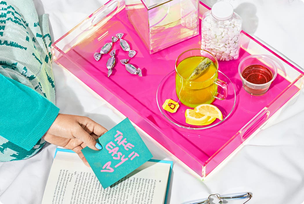 tray of tea, tissues and cough drops with a note saying "take it easy"