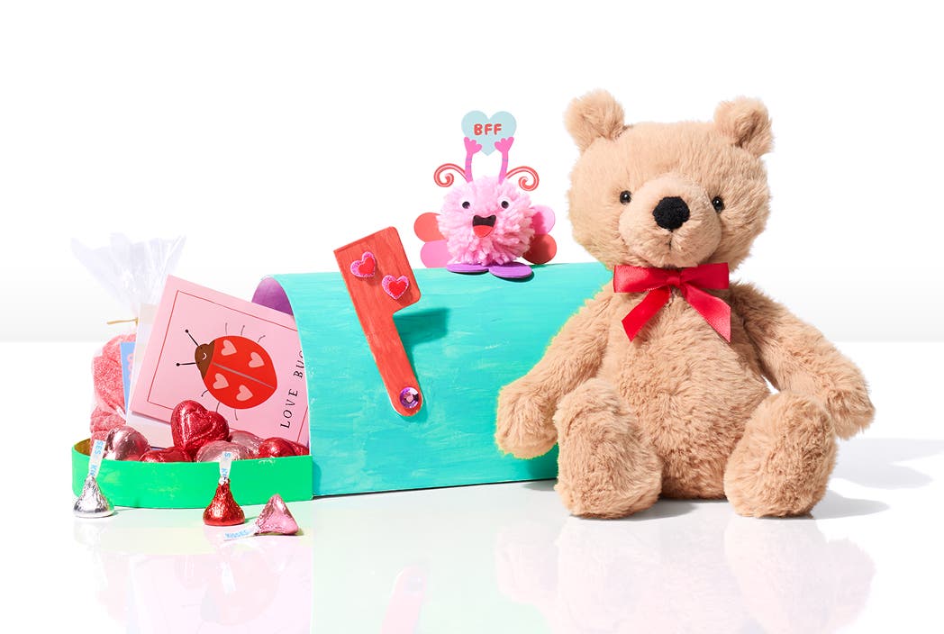 teddy bear with a card and chocolate in a mailbox