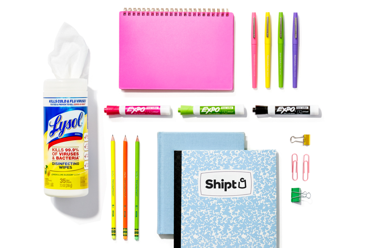 Colorful selection of notebooks, dry erase markers, pencils, and pens on a white background