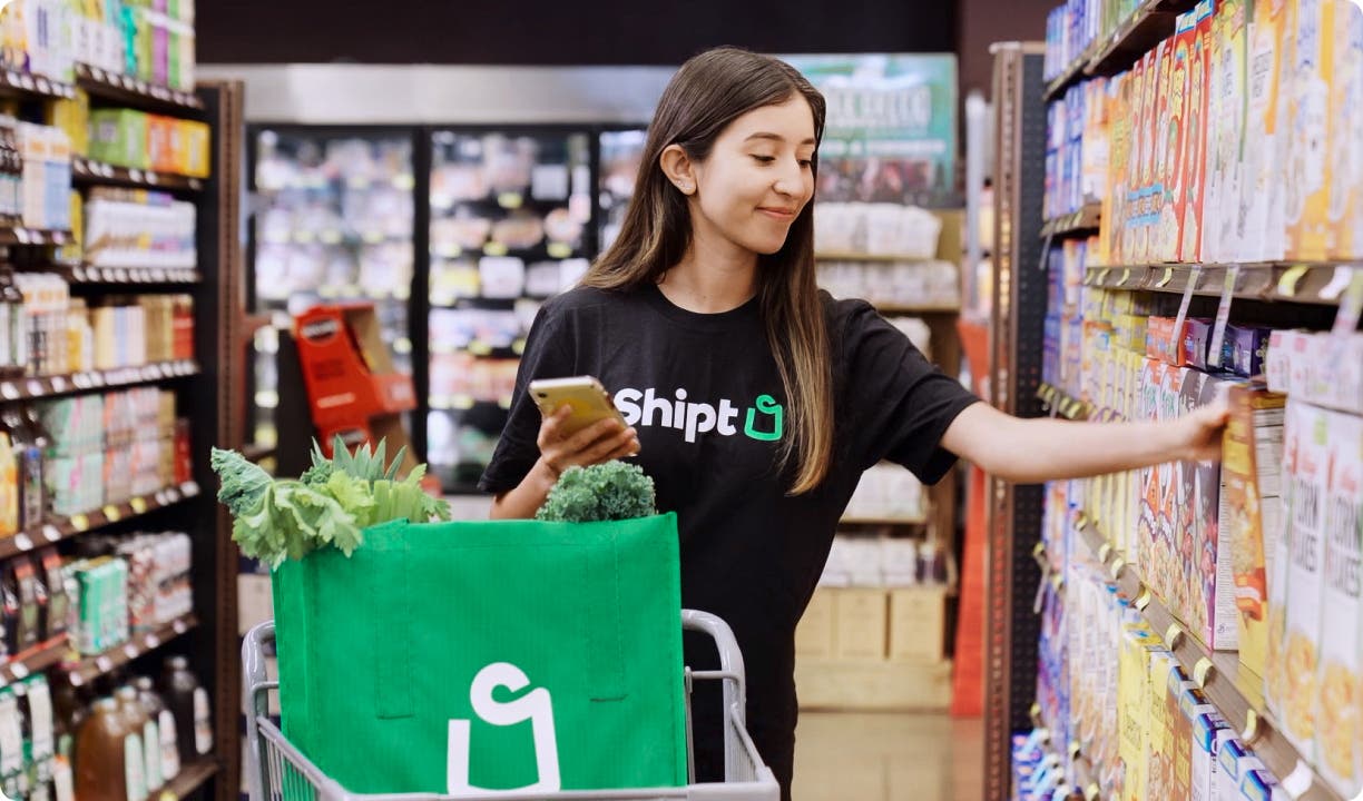 Shipt shopper choosing a product off the store shelf
