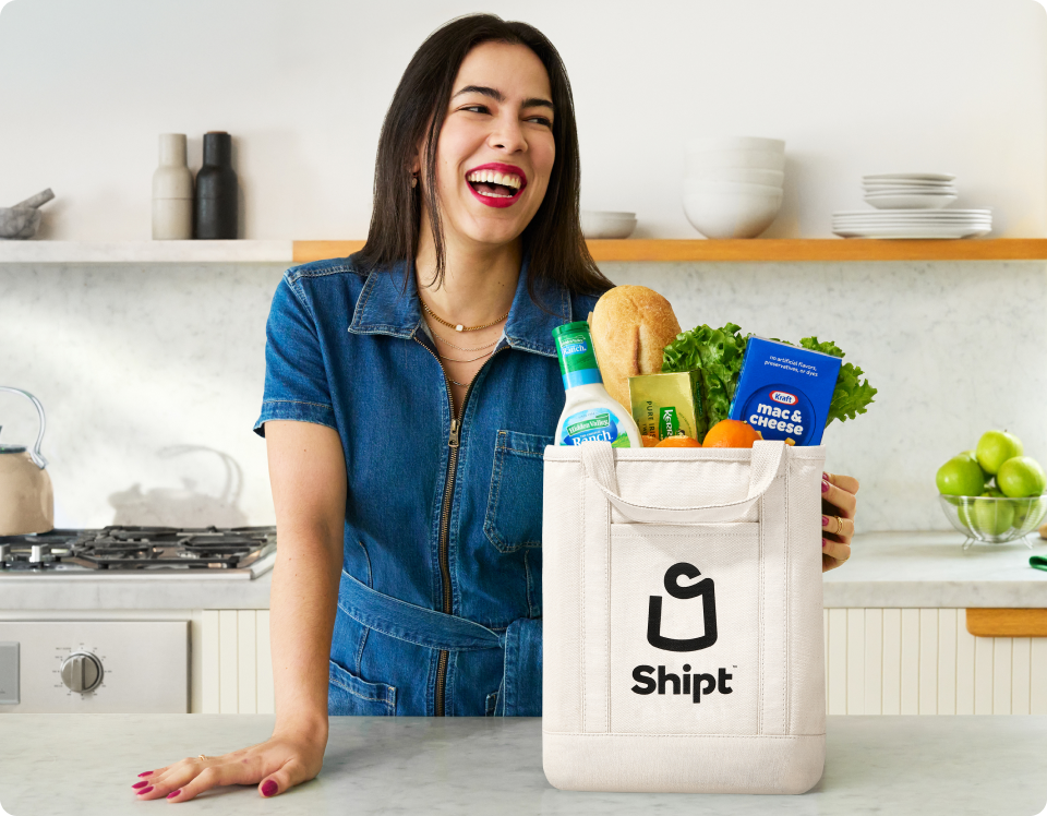 Woman unpacks bag of Shipt groceries