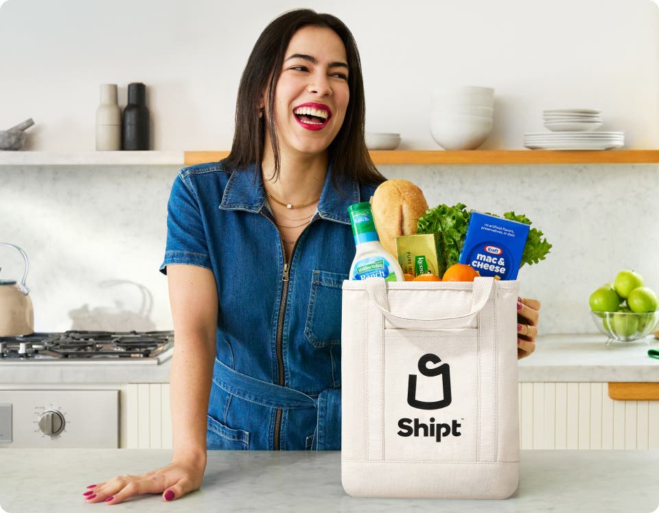 Woman unpacks bag of Shipt groceries